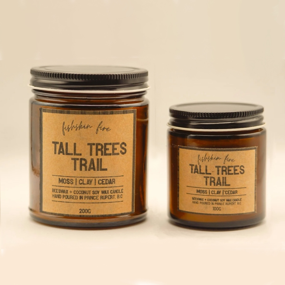 Two candles labeled 'Tall Trees Trail' on a beige background