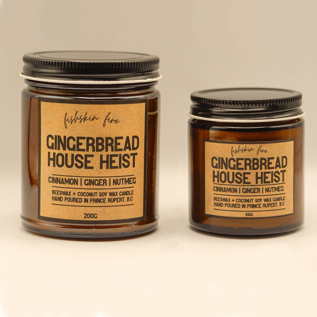 Two gingerbread-themed candles with labels on a neutral background