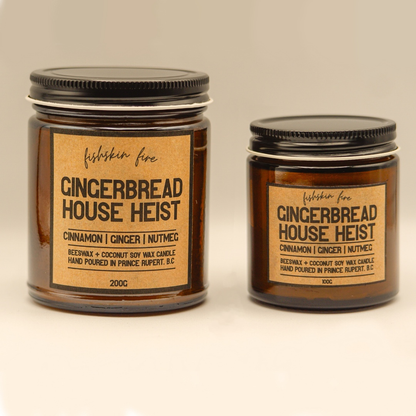 Two gingerbread-themed candles with labels on a neutral background